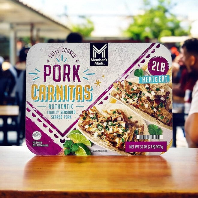 Packaging of Member's Mark Fully Cooked Pork Carnitas - 2 lbs - 1 Box, featuring a heat-and-eat option with images of tacos and lime garnish to highlight its slow-cooked flavor.