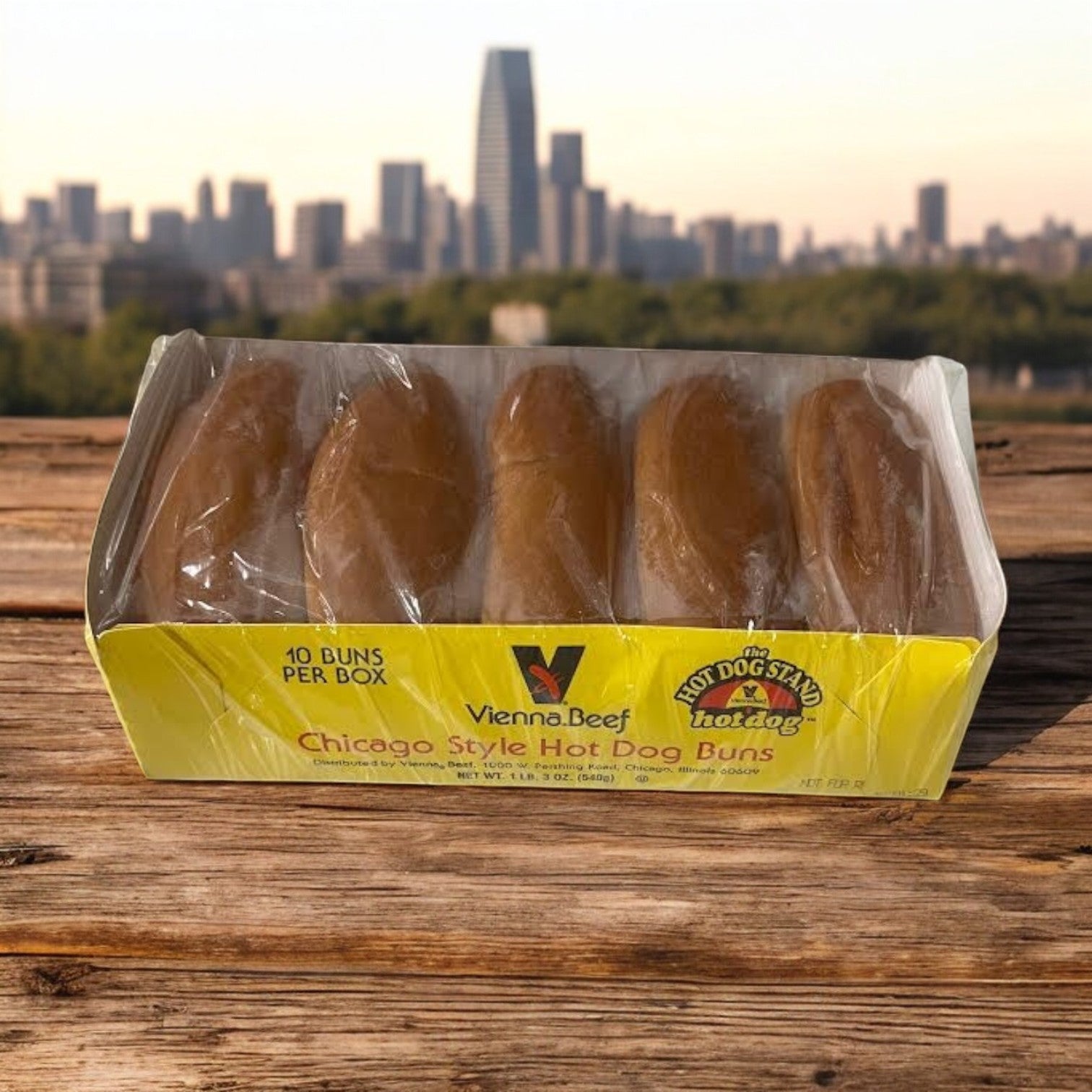 A package of Vienna Beef Plain Hot Dog Buns-12/10 Count Pack Case-120 Per Case sits on a wooden surface with a blurred city skyline in the background.