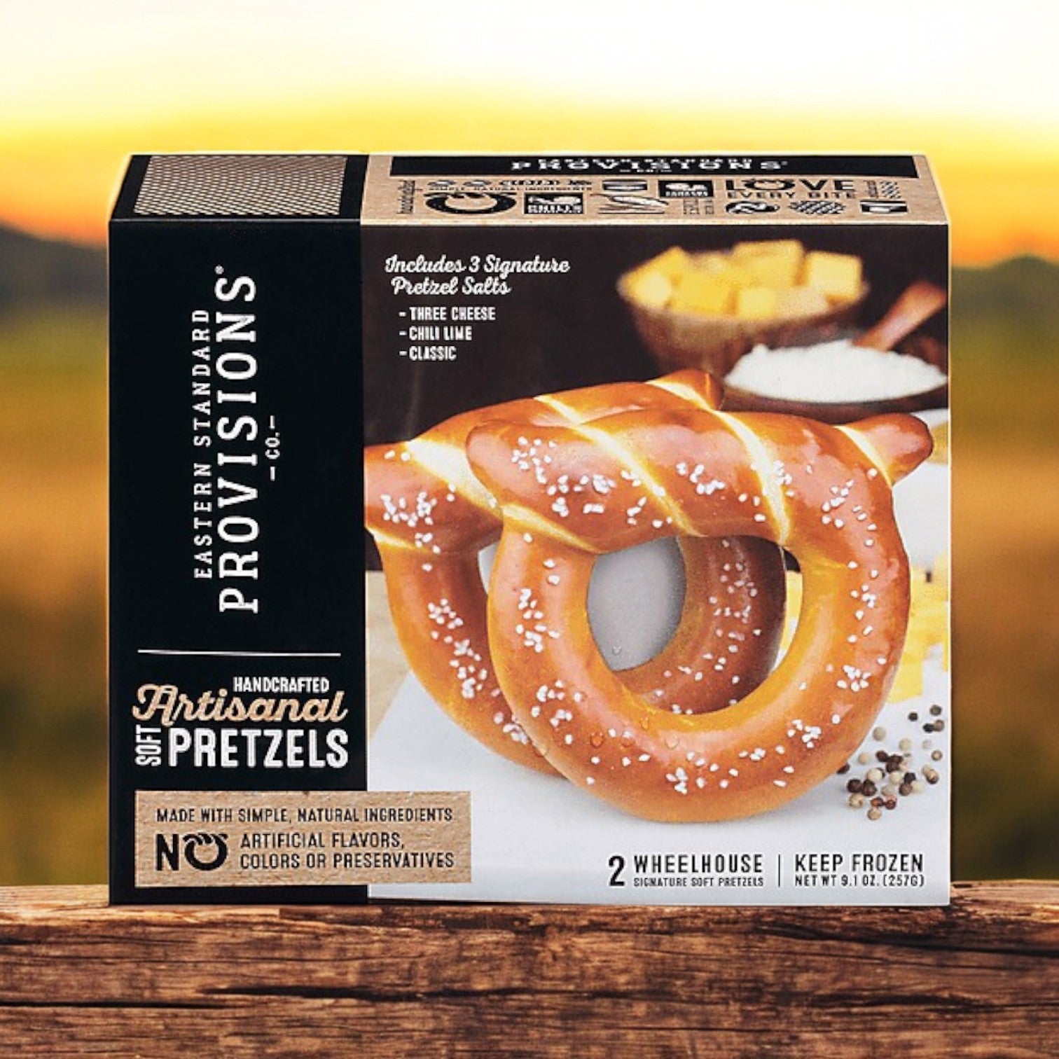 Eastern Standard Provisions 2 Pack Combo! on a wooden surface, showcasing soft pretzels and three delectable dips: Three Cheese, Chili Lime, and Classic.