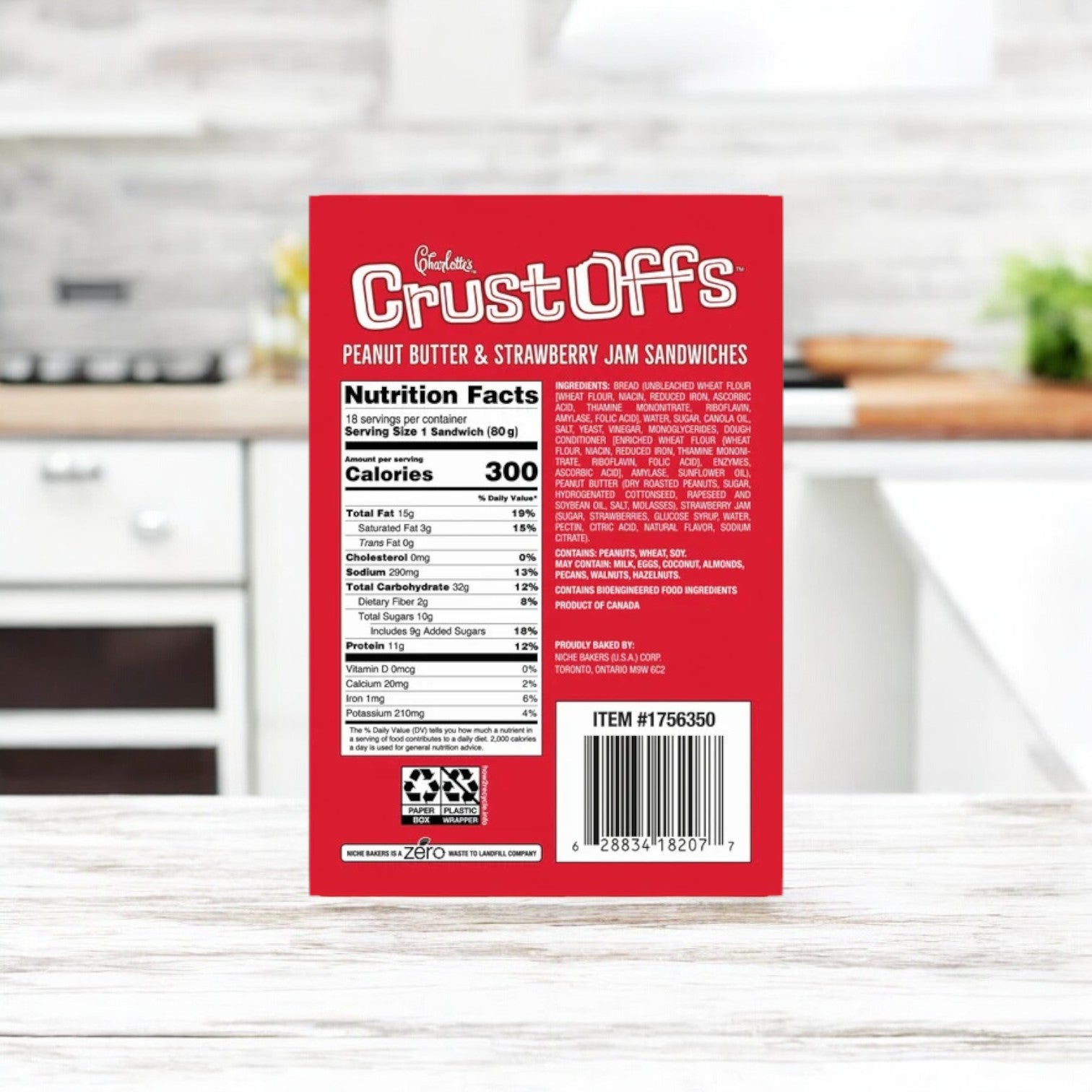 A box of Crust Off's Charlotte's Crust Offs Sandwiches, Peanut Butter & Strawberry Jam, 2.2 oz. - 3 Box rests on the kitchen countertop beside the nutrition facts display.