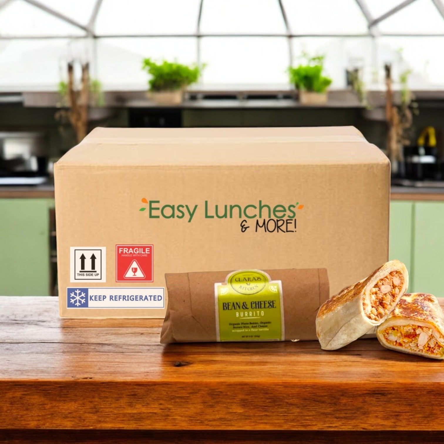A wooden surface holds a Clara's Kitchen Individually Packaged Bean & Cheese Burrito, sliced open to reveal its vegetarian filling, with a kitchen backdrop.