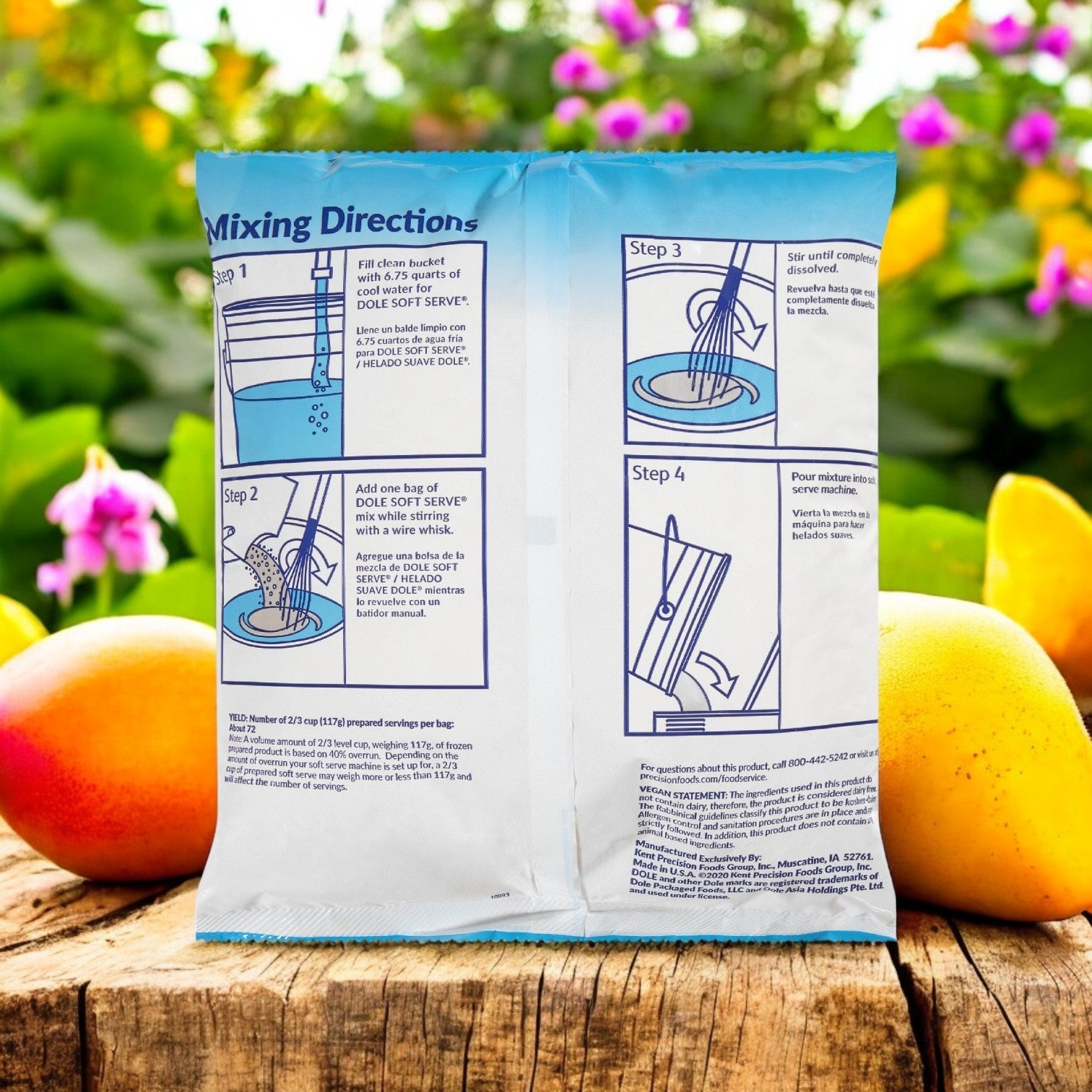 A bag of Dole Soft Serve Mix Mango sits on a wooden surface, surrounded by colorful flowers and fruit, suggesting a tropical flavor ideal for making your own mango treat.
