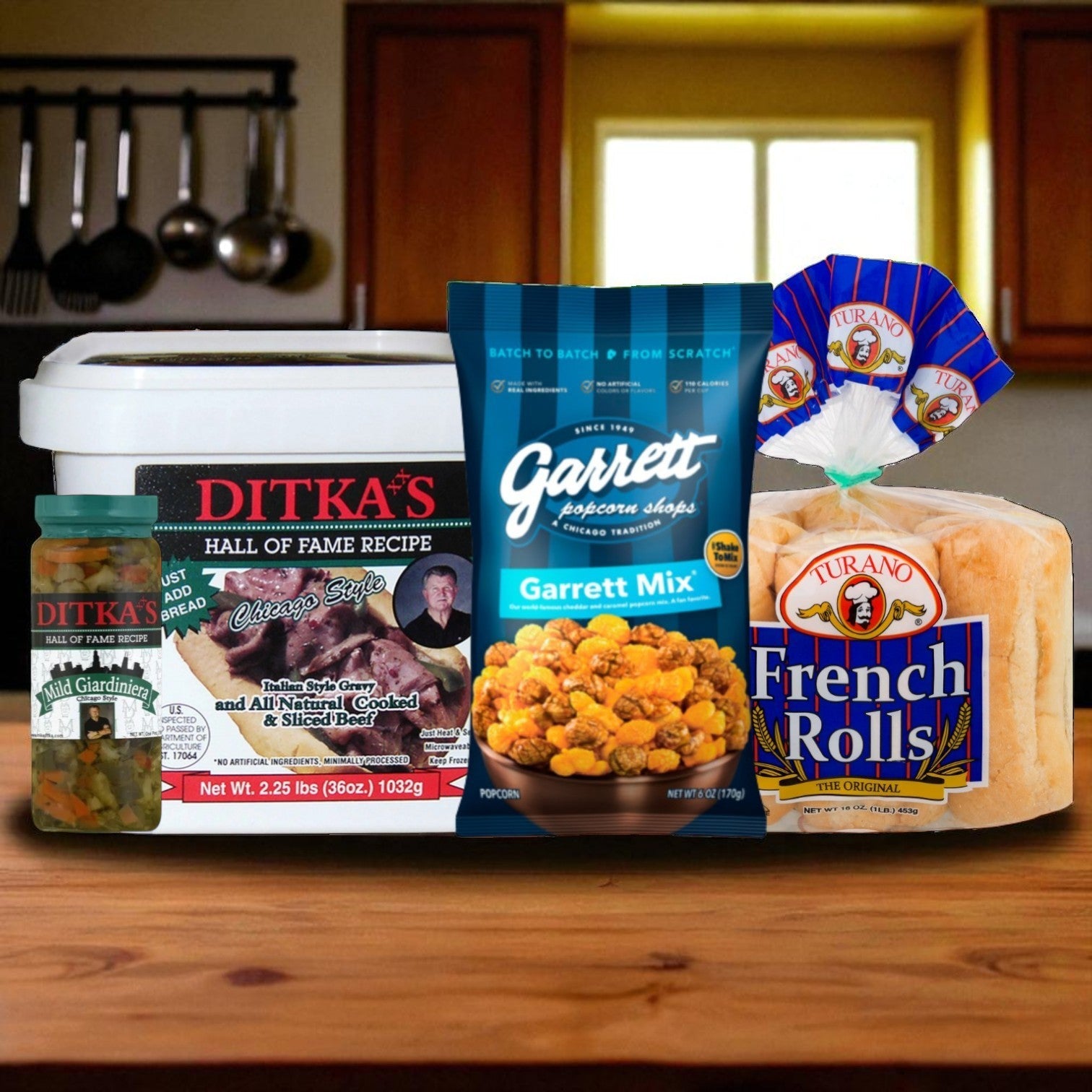 The Vienna Beef Chicago Classics Bundle—Italian Beef, Giardiniera & Garrett Mix—is displayed with French rolls on a kitchen counter, featuring cabinets and a window in the background.