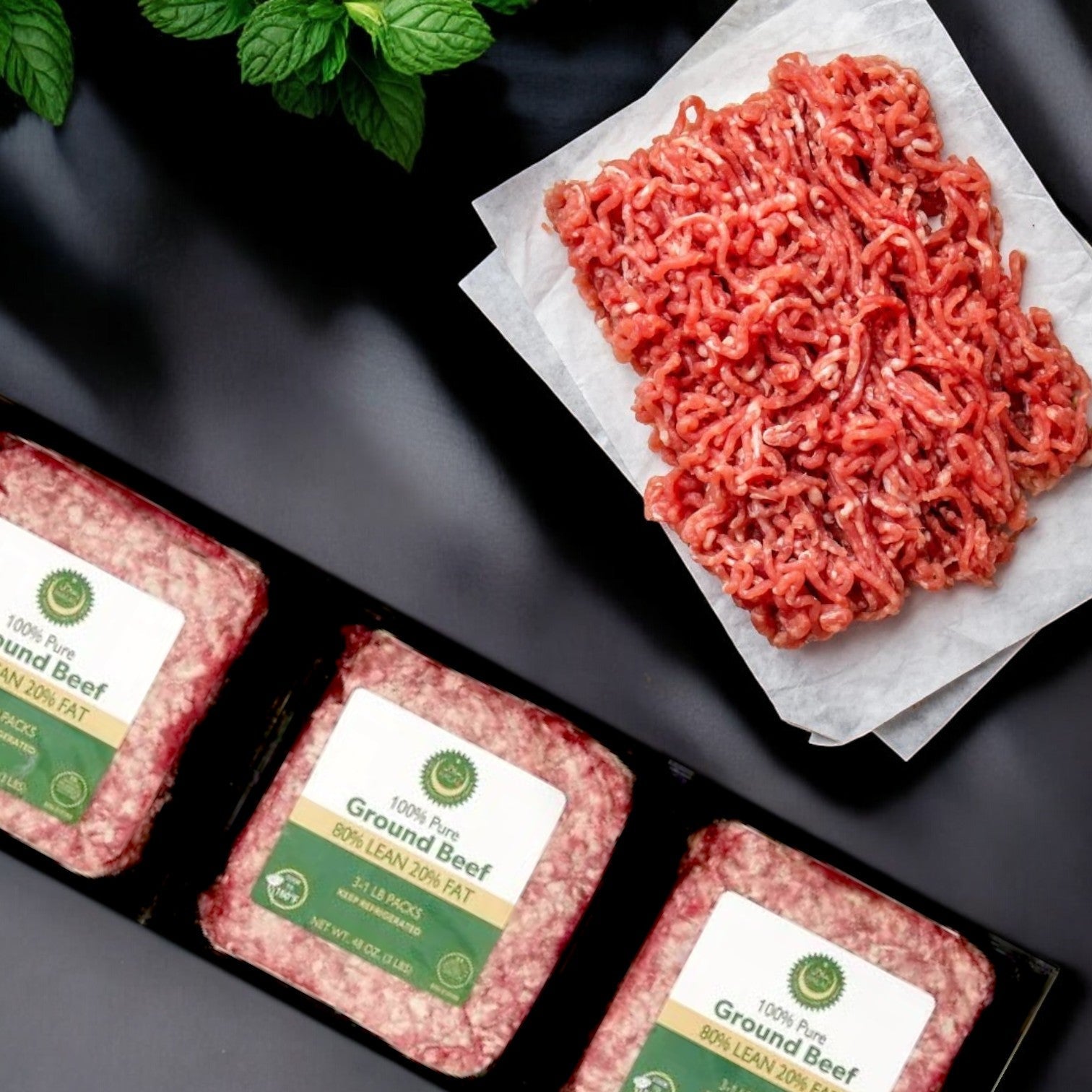 Crescent Foods' 3 lbs packs of Halal Ground Beef labeled as 80% lean are neatly arranged. Beside them, some raw meat is displayed on parchment, adorned with a fresh mint sprig in the corner, inviting culinary creativity.