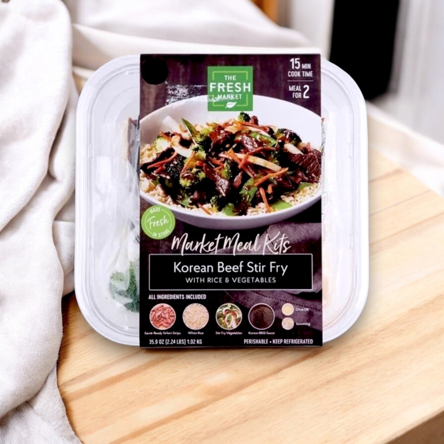 Experience authentic Korean flavors in just 15 minutes with The Fresh Market's Korean Beef Stir Fry Meal Kit, featuring beef, fresh vegetables, and rice in a 36 oz plastic container for two servings.