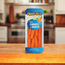 A pack from Dippin Stix's 12 Pack of Baby Carrots & Ranch Dip rests invitingly on a wooden kitchen surface, offering a convenient and healthy snack option.