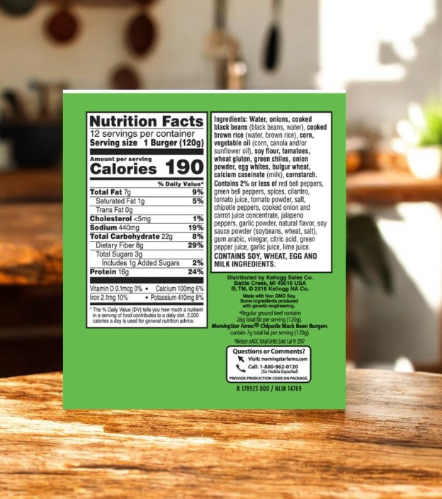 Close-up of a nutritional facts label on a green-packaged MorningStar Farms Chipotle Black Bean Burger, 12 Count-1 Pack, highlighting serving size, calories, plant-based protein ingredients, and contact info. Blurred kitchen background.