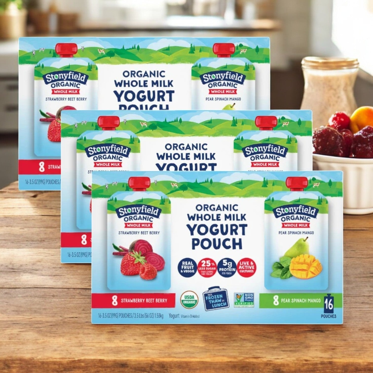 Twelve pouches of Stonyfield's Organic Yogurt sit on a wooden table, featuring strawberry and mango flavors. Packed with rich probiotics and vitamins, these yogurt pouches are a deliciously healthy choice for everyone.