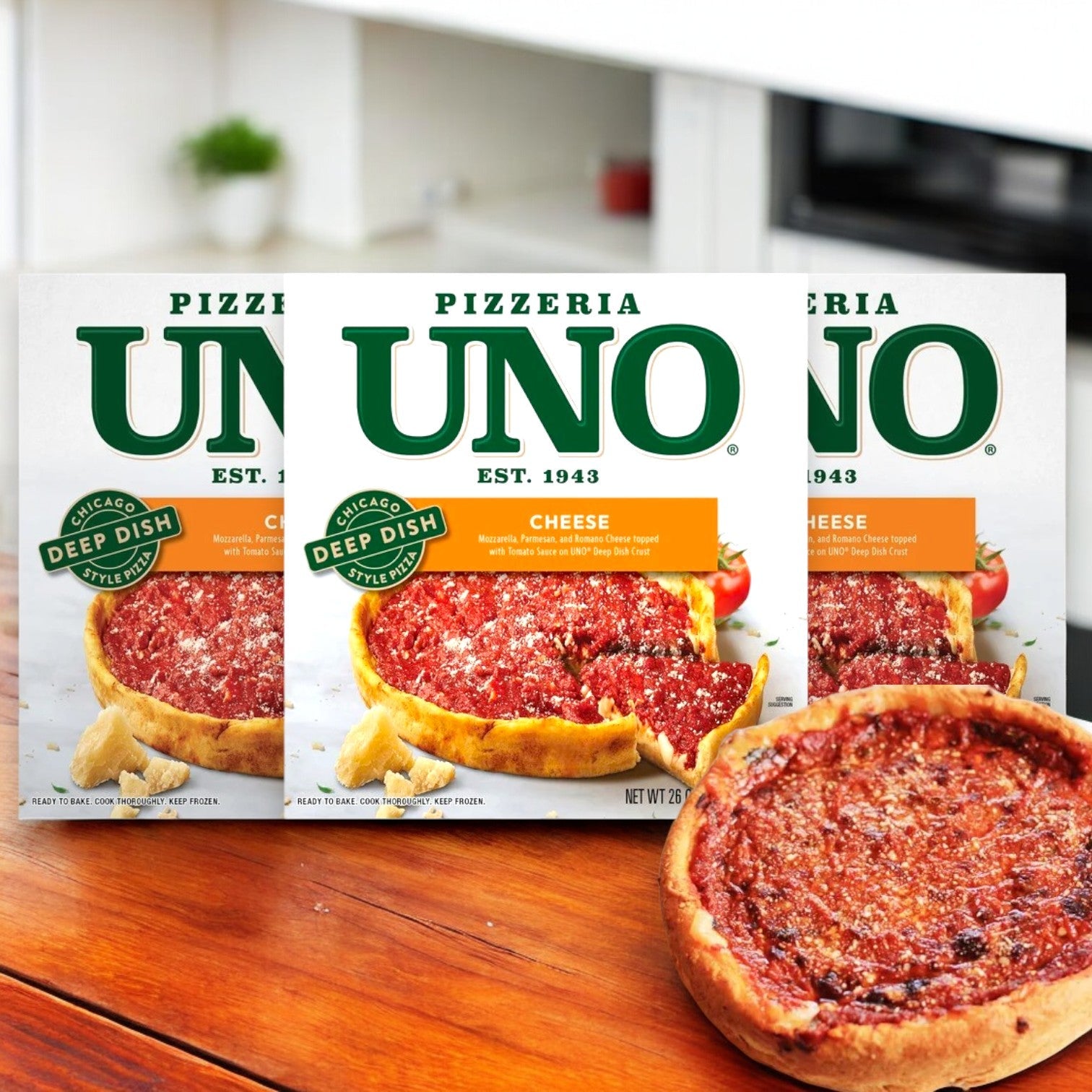 Three Uno Chicago Style Deep Dish Cheese Pizzas, 26 oz., are displayed, highlighting the buttery crust and rich mozzarella cheese, with one opened pizza in front.