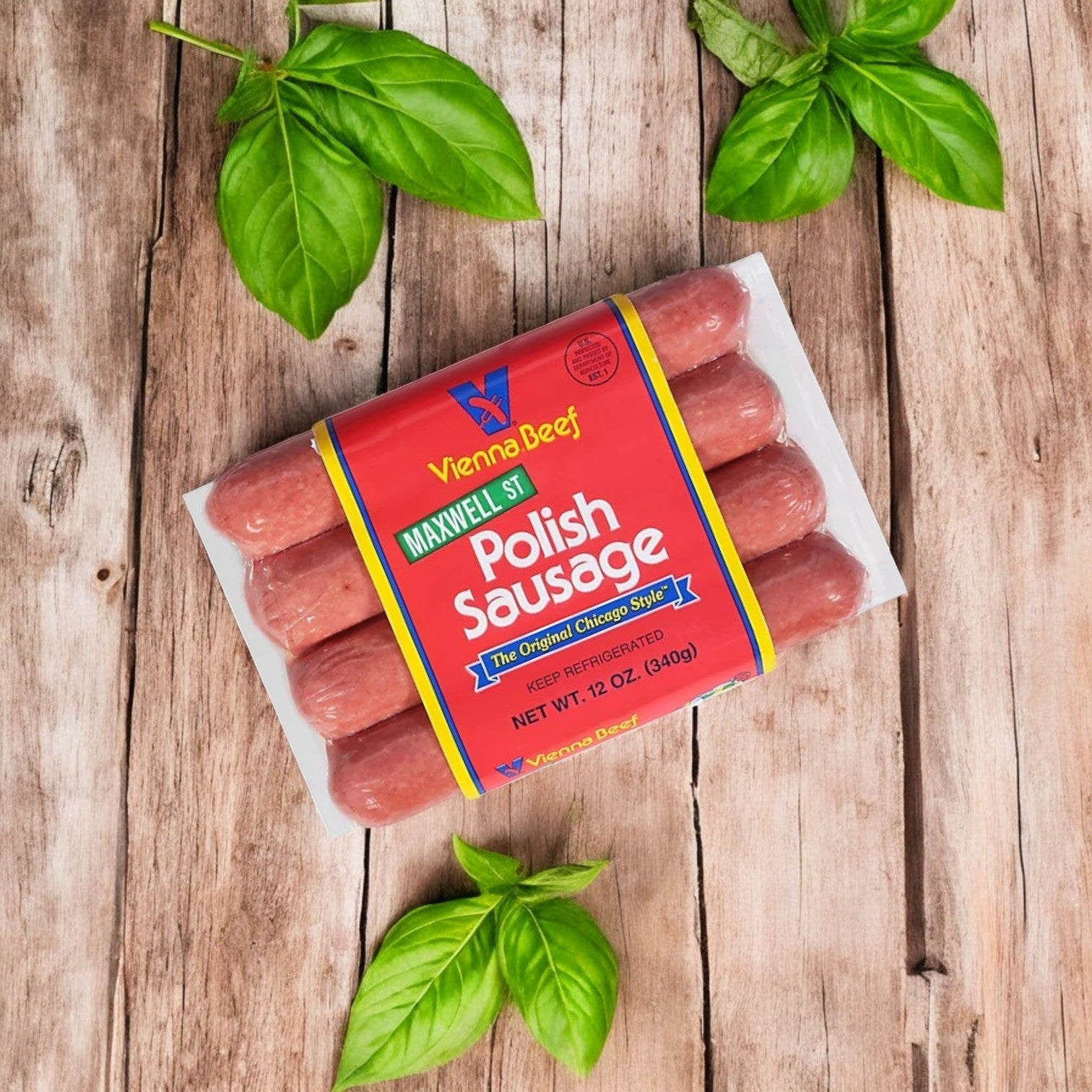 Vienna Beef Variety Pack featuring Chicago's finest sausages with natural casing displayed on wood, surrounded by fresh basil leaves.