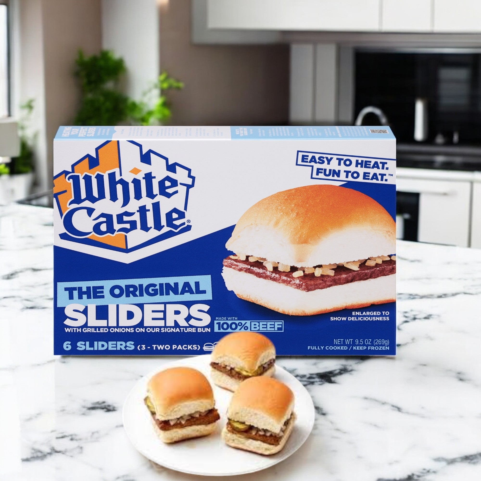 A box of White Castle Microwaveable Hamburgers - 6 Count- 1 Pack rests on a marble kitchen counter, with a plate displaying three tasty sliders in the foreground.