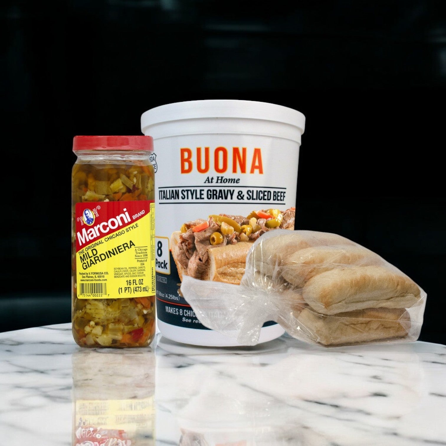 A Buona Beef 8 Pack Kit with Marconi Mild Giardiniera and packaged bread rolls on a marble surface.