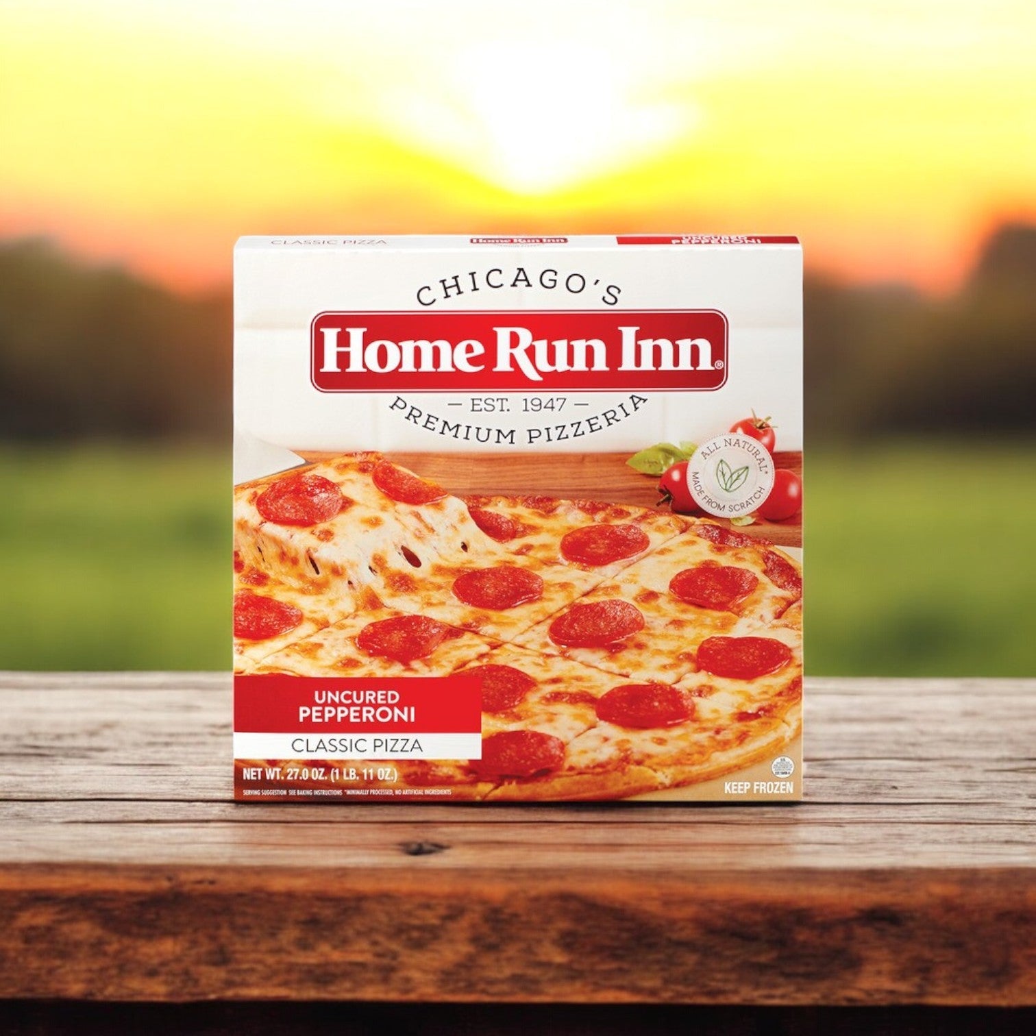 A Frozen Easy Lunches Home Run Inn and Vienna Beef Chicago-Style Favorites Combo!!! box sits on a wooden surface with uncured pepperoni, showcasing true Chicago-style elegance against a blurred outdoor backdrop.