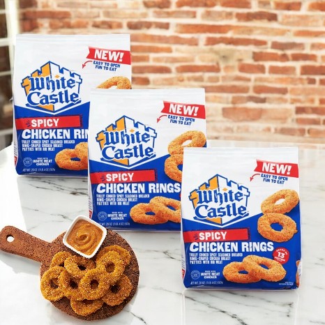 White Castle Spicy Chicken Rings-20 Oz-3 Count are perfect for a bold snack adventure. Enjoy a serving on a wooden board with a savory dipping sauce.