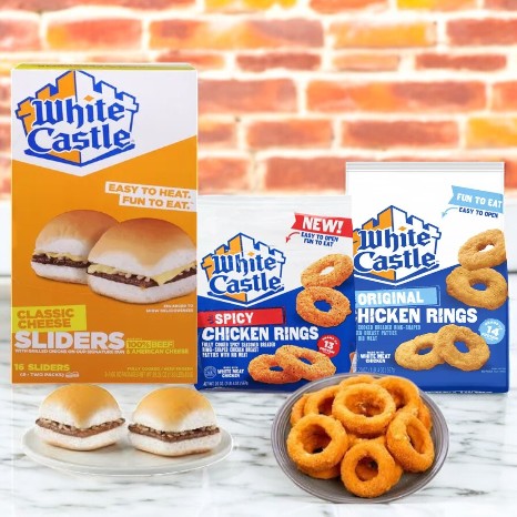 Displayed are White Castle products: the 3 Pack Combo! which includes classic sliders, cheeseburgers, and spicy chicken rings in packages. Two sliders and fried rings are shown on a plate in front.