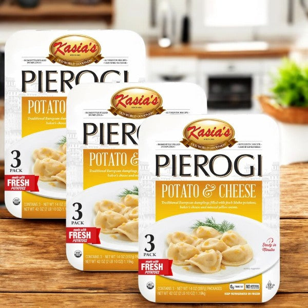 Three packs of Kasia's Pierogi Potato & Cheese (14 oz, 3 count) feature a trio of delicious pierogi per pack, with packaging displaying an enticing image set against a kitchen backdrop and natural ingredients.