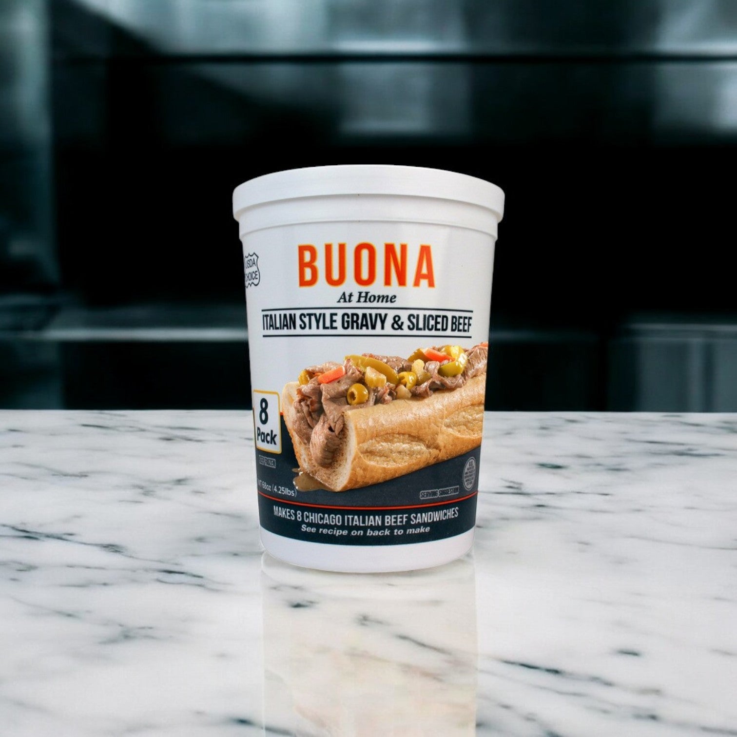 A "Buona Beef 8 Pack Kit!" from Buona sits elegantly on a marble surface, capturing the essence of Chicago-style Italian beef with every savory drop.