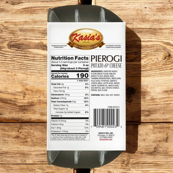 A 14 oz, 3 count box of Kasia's Pierogi Potato & Cheese rests on a wooden surface, highlighting its authentic flavor with visible nutrition facts and barcode.