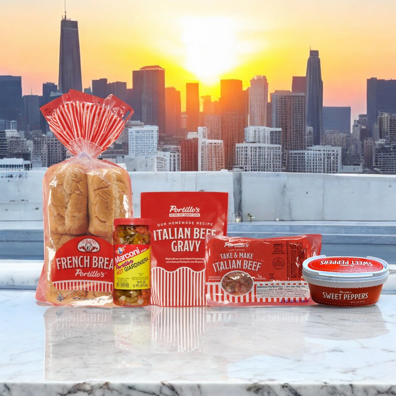 Portillo's 8 Italian Beef Sandwich Combo, complete with French bread, Italian beef gravy, a sandwich, hot giardiniera, and sweet peppers, is elegantly displayed on a marble surface with a city skyline and sunset in the backdrop. Perfect for parties!.