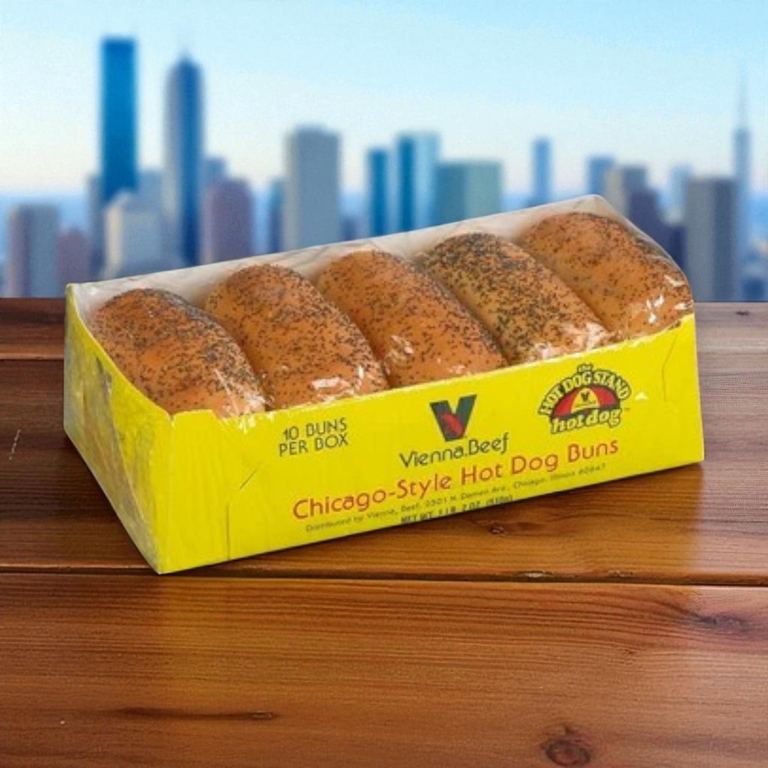 A package of Vienna Beef Ditka’s Hot Polish Sausage & Poppy Seed Bun Pack sits on a table with the Chicago skyline blurred in the background—perfect for serving authentic Chicago-style hot Polish sausages.