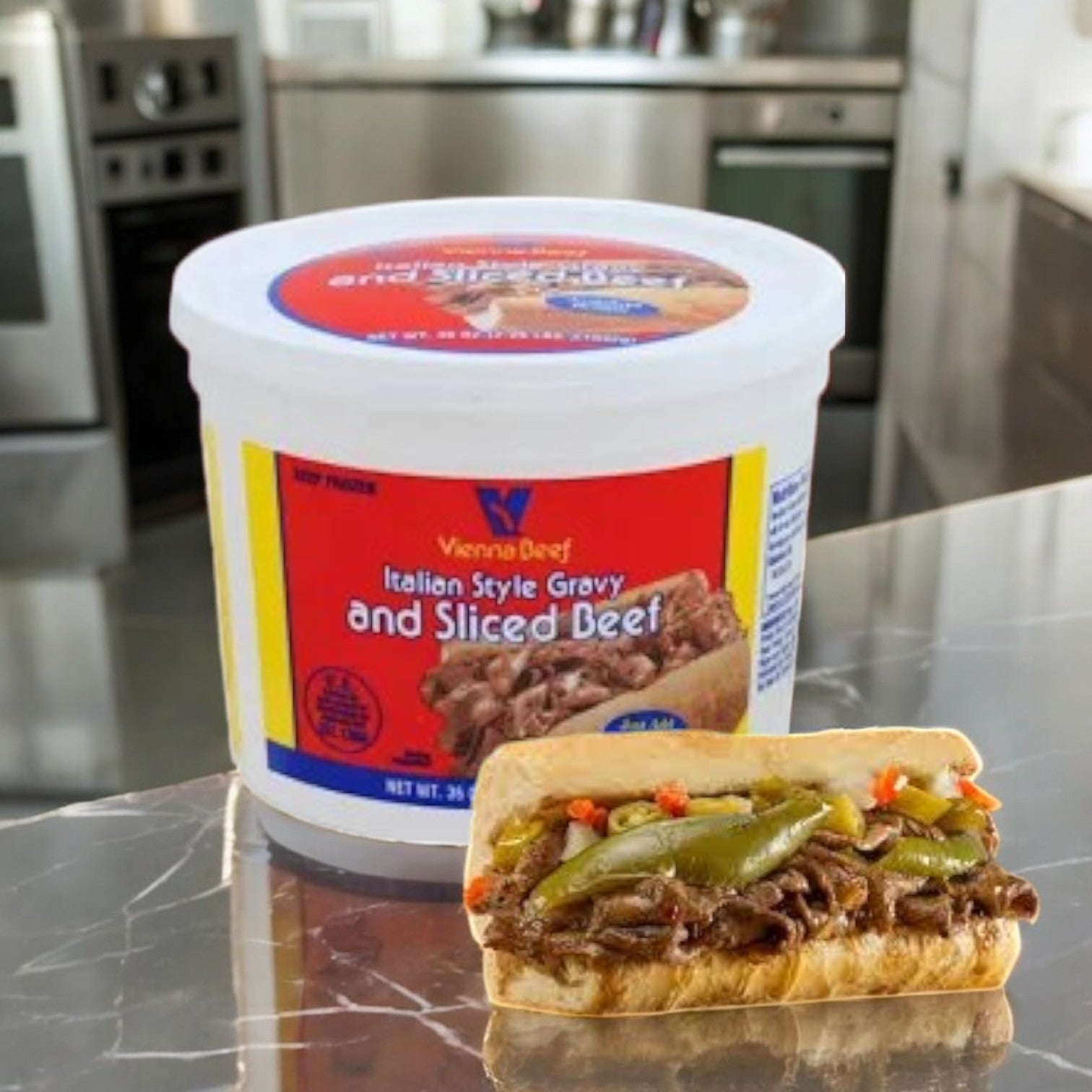 A Vienna Beef Italian Style Gravy and Sliced Beef tub sits on the counter, showcasing a Chicago-style sandwich loaded with beef, peppers, and vegetables.
