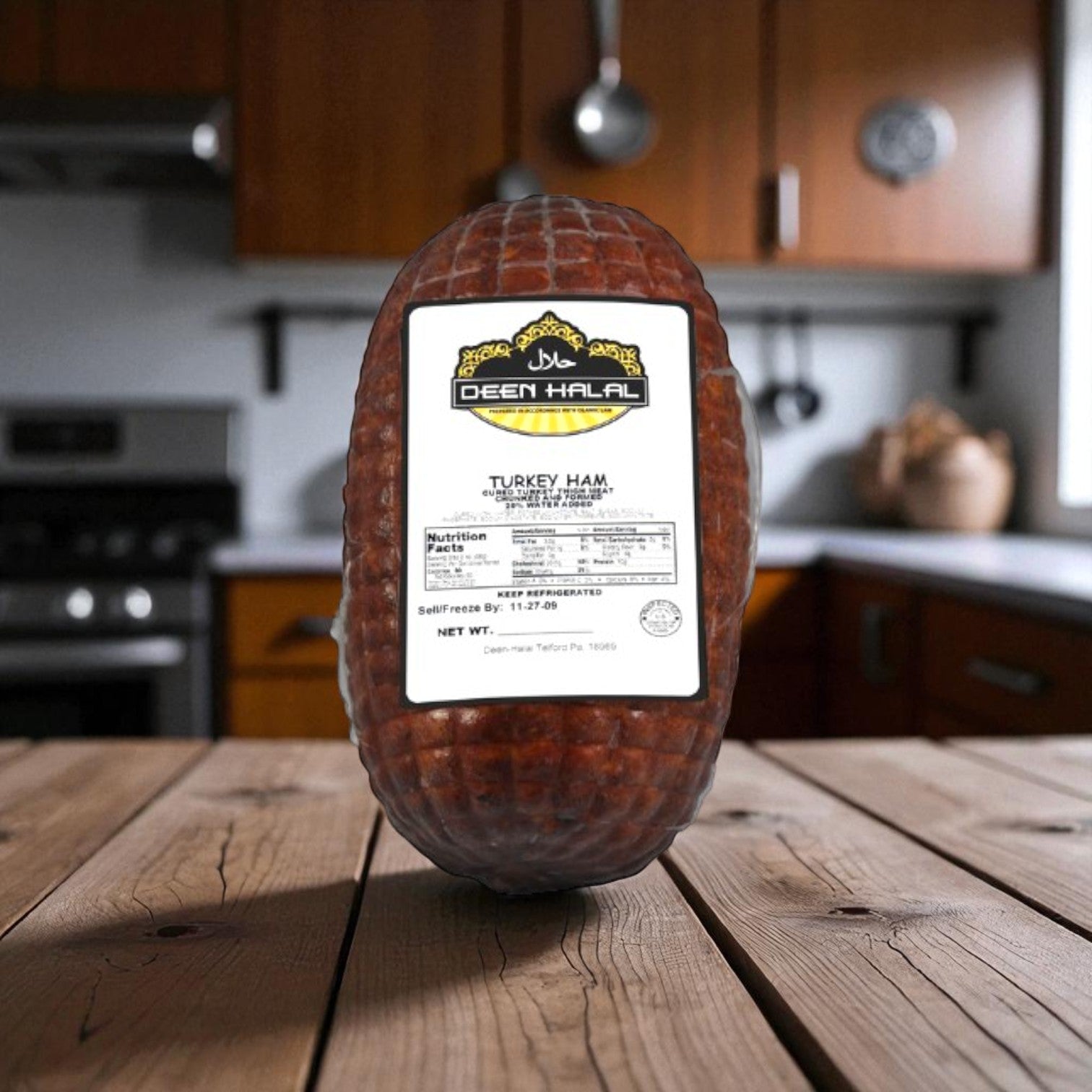 A case of Dean Halal Turkey Ham from Restaurant Depot stands upright on a wooden kitchen table with matching cabinets and countertops, ideal for bulk deli meat needs.